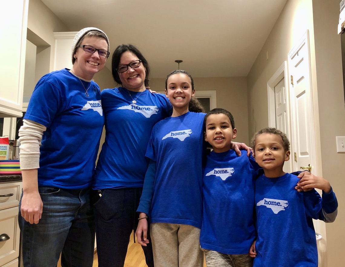 Family of five talks about how to move to another state, happily wearing new NC t-shirts